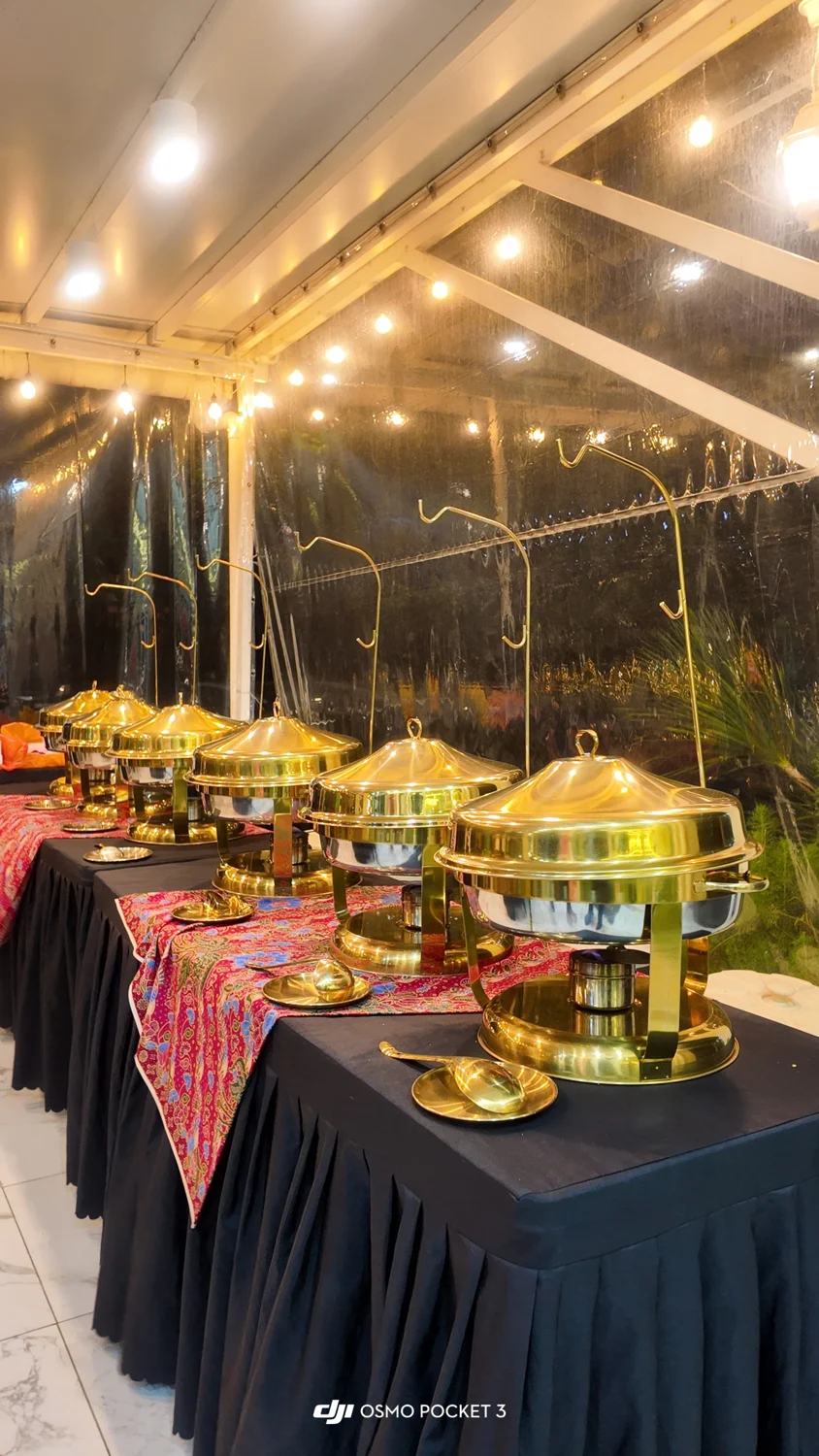 A buffet with warm evening lighting and event decorations